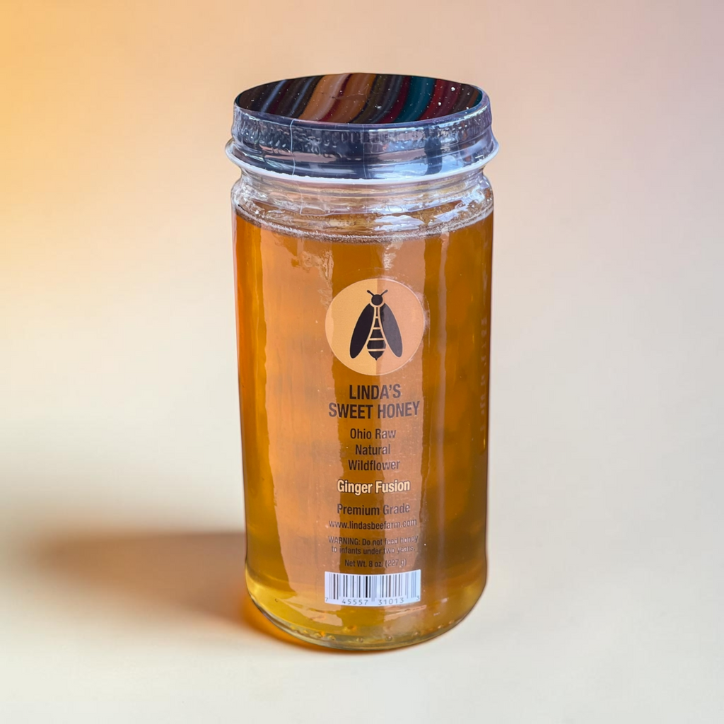Jar of Linda's Ginger Fusion honey on a soft peach background