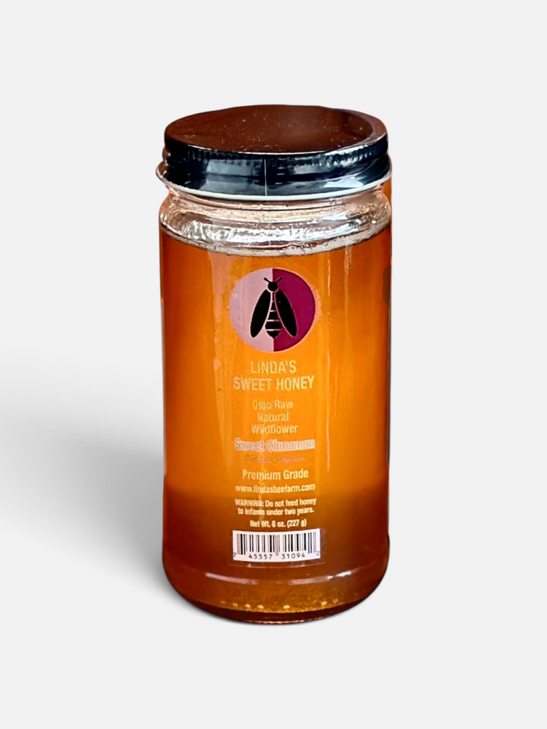 Jar of Linda's Cinnamon Fusion honey on a white background