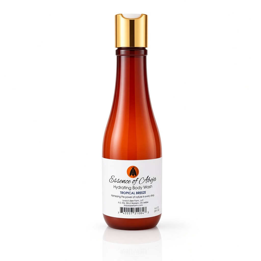 A bottle of Essence of Abeja Hydrating Body Wash in Tropical Breeze scent, featuring an amber-brown translucent bottle, a white label, and a metallic gold cap, set against a plain white background with a soft reflection.
